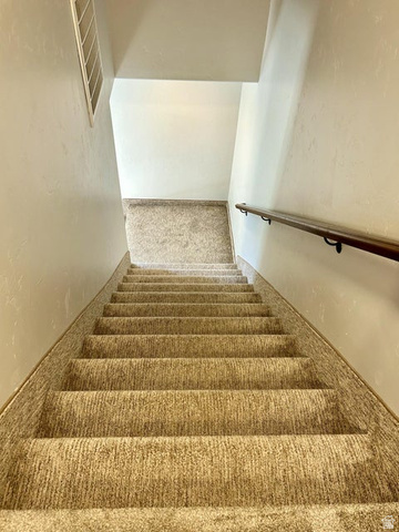 310 625 East Enterprise, UT 84725 - Photo 24 of 36 Carpeted staircase with a wood-finish handrail and light-toned wall finishes
