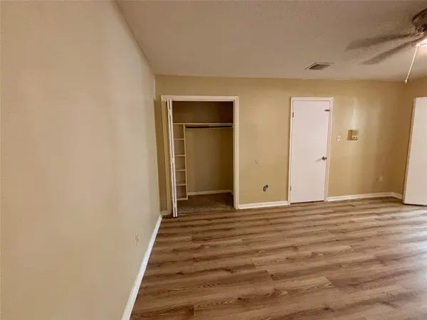 a view of a livingroom with wooden floor and stairs