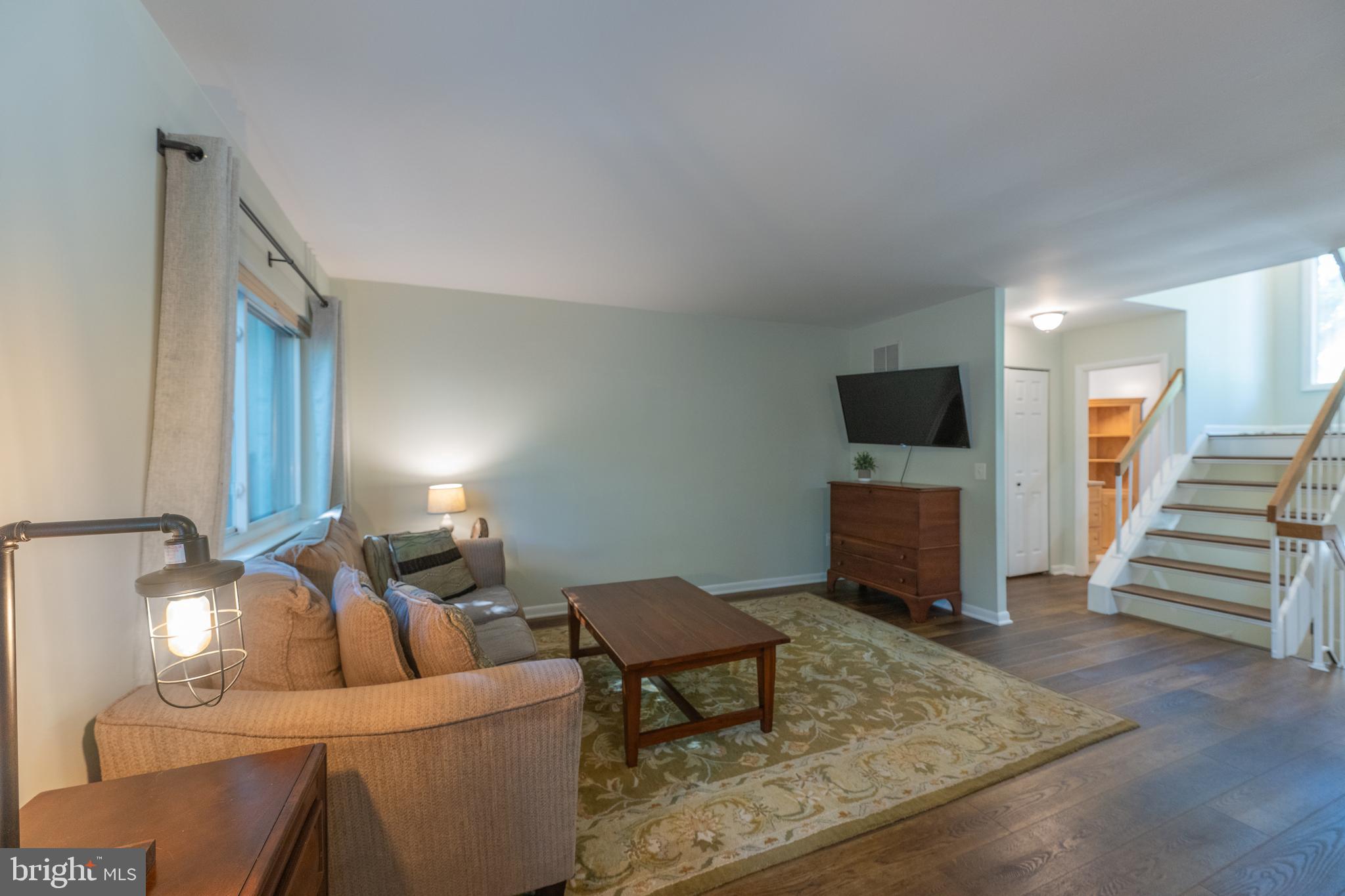 11917 Barrel Cooper Court Reston, VA 20191 - Photo 21 of 59 a living room with furniture and a flat screen tv