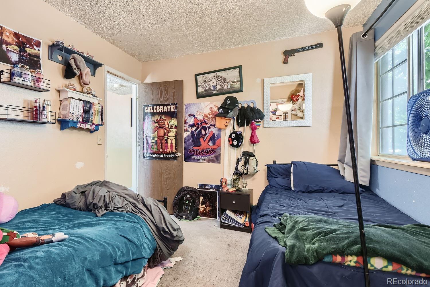 882 South Uravan Court Aurora, CO 80017 - Photo 13 of 33 a bed room with a bed and a couch