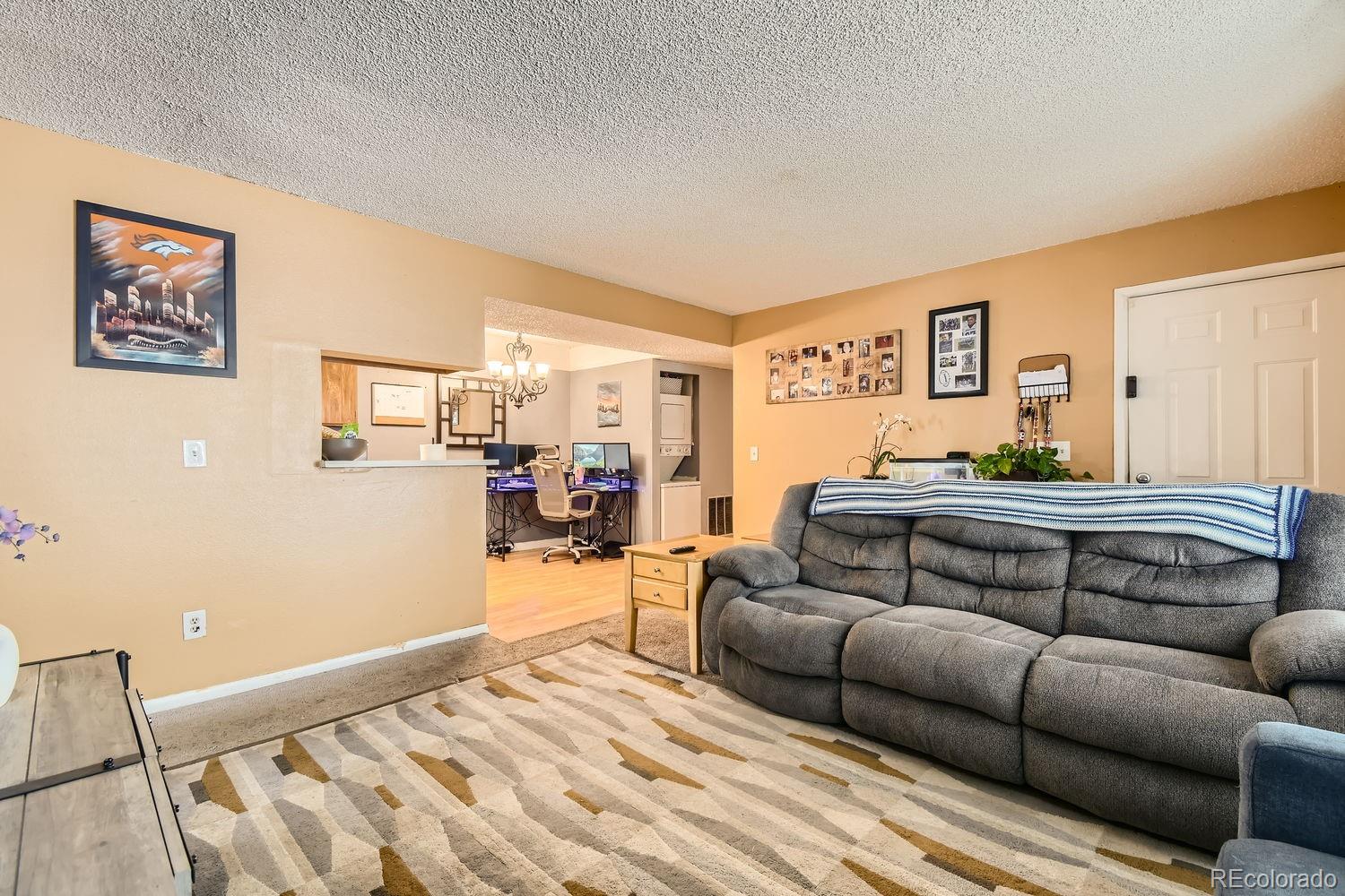 882 South Uravan Court Aurora, CO 80017 - Photo 14 of 33 a living room with furniture and a wooden floor