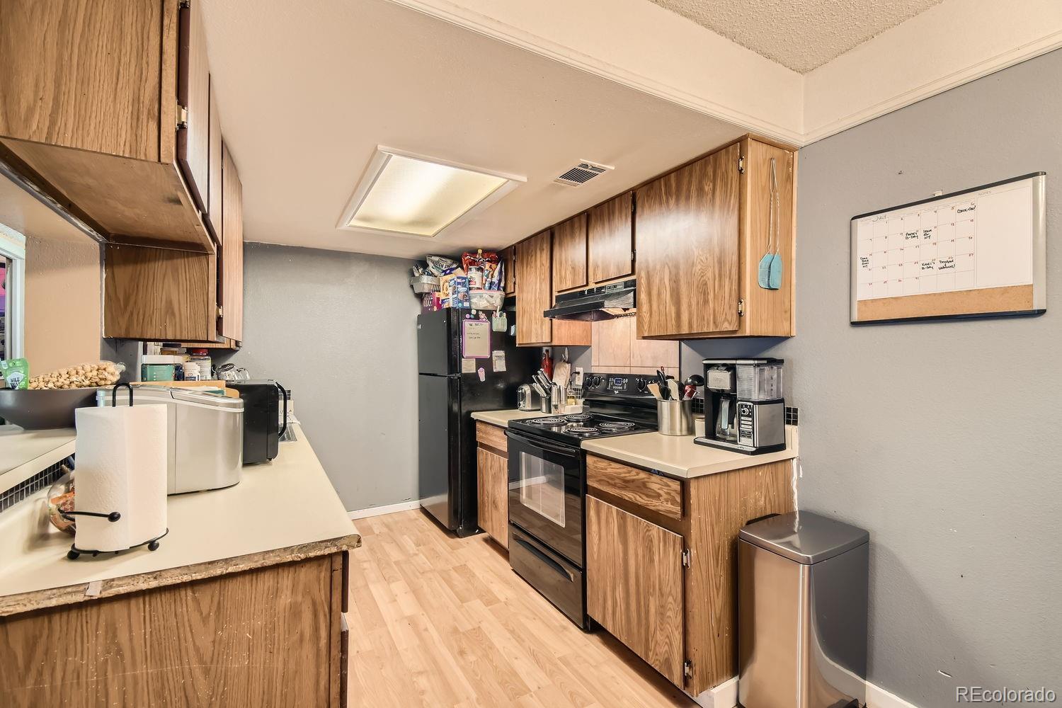 882 South Uravan Court Aurora, CO 80017 - Photo 15 of 33 a kitchen with a sink appliances and cabinets