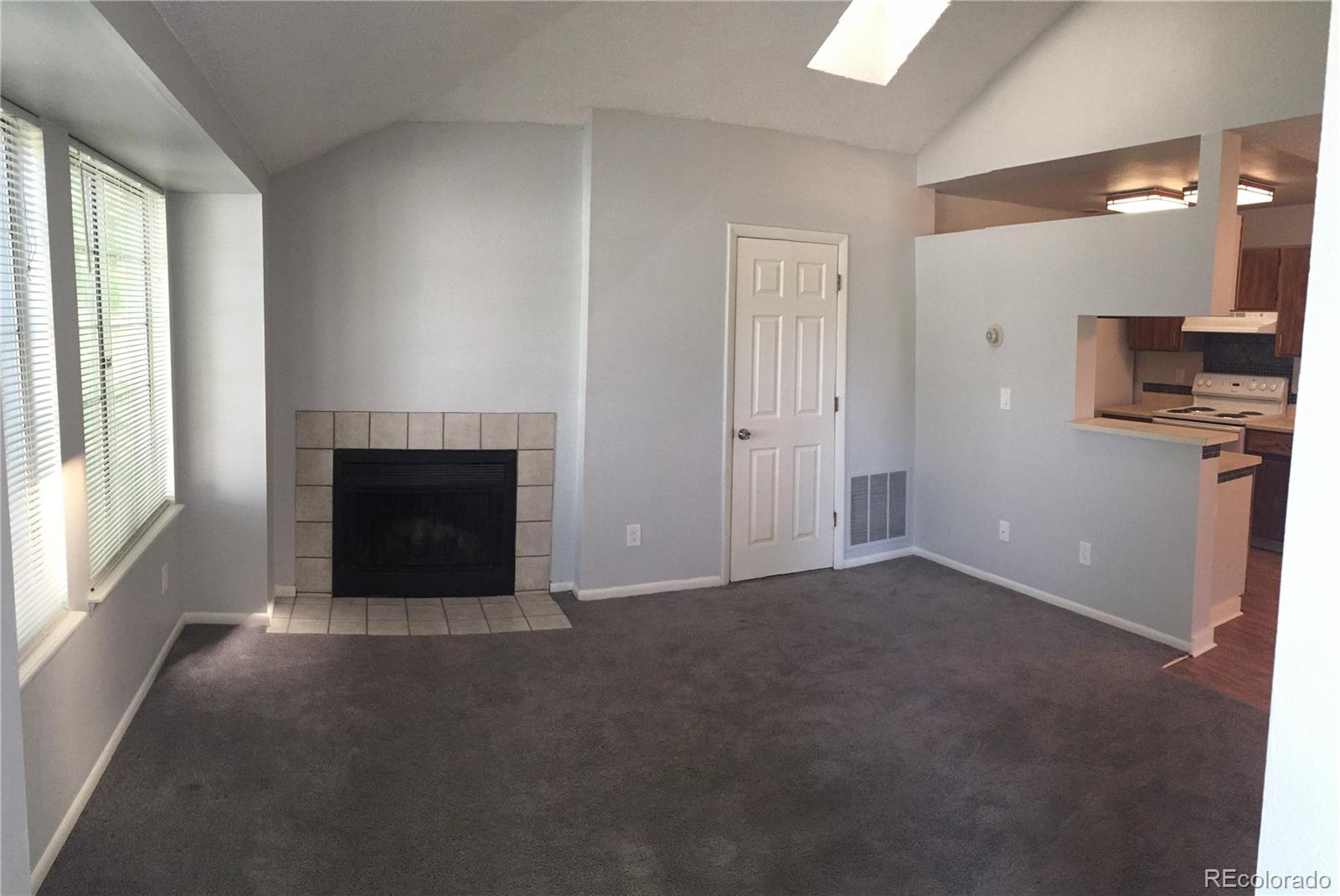 882 South Uravan Court Aurora, CO 80017 - Photo 26 of 33 a view of empty room with a fireplace