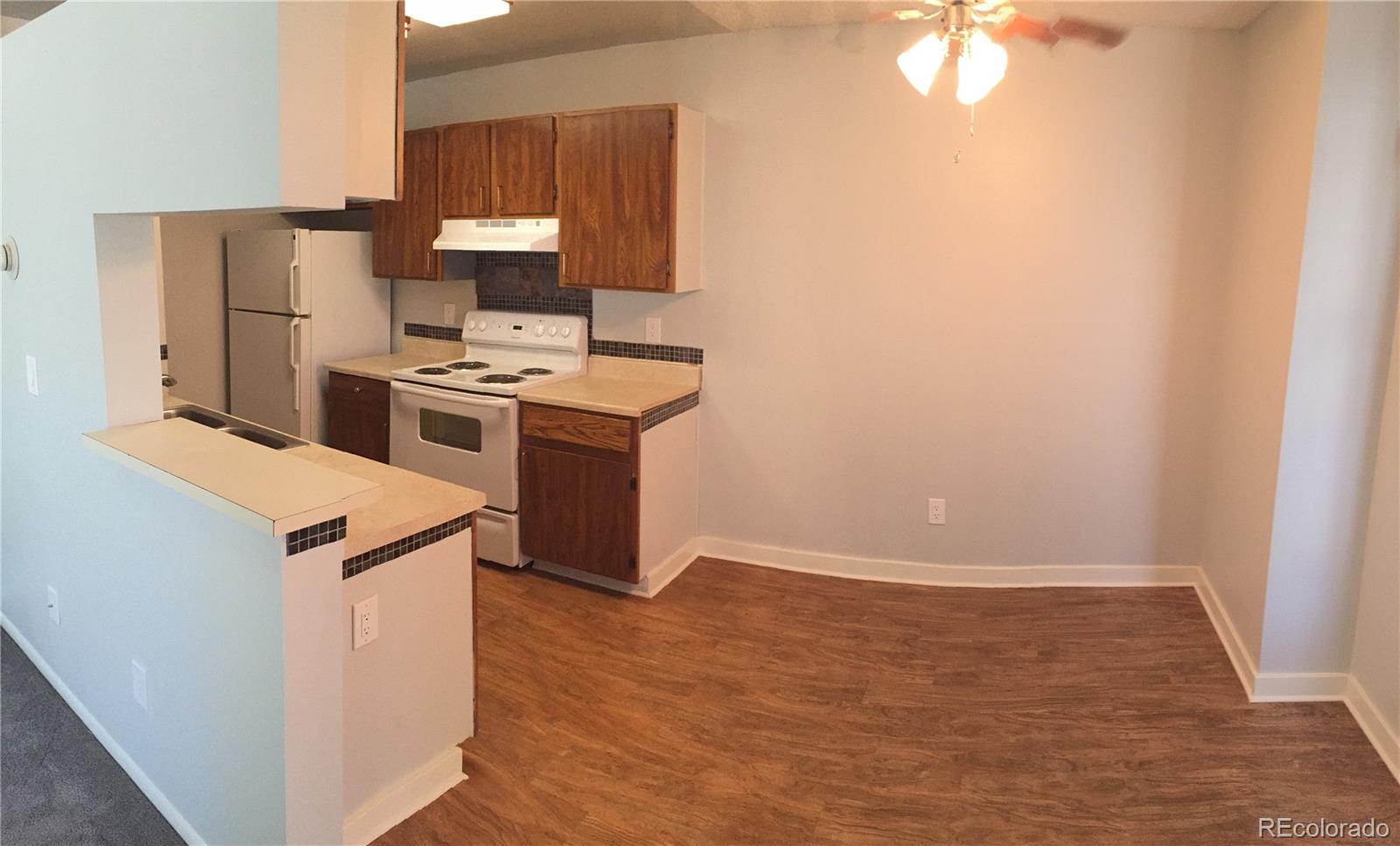 882 South Uravan Court Aurora, CO 80017 - Photo 28 of 33 a kitchen with a stove and a refrigerator