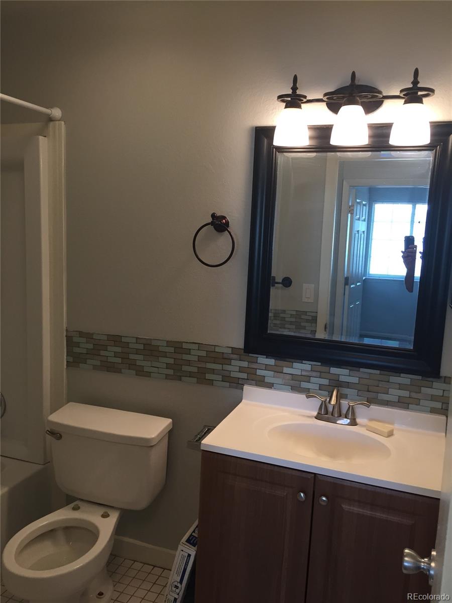 882 South Uravan Court Aurora, CO 80017 - Photo 30 of 33 a bathroom with a toilet sink and mirror