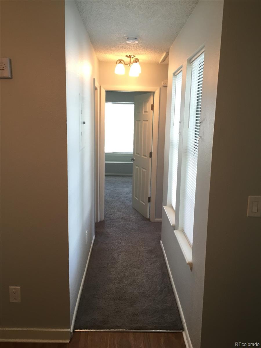 882 South Uravan Court Aurora, CO 80017 - Photo 31 of 33 a view of hallway with shower and door
