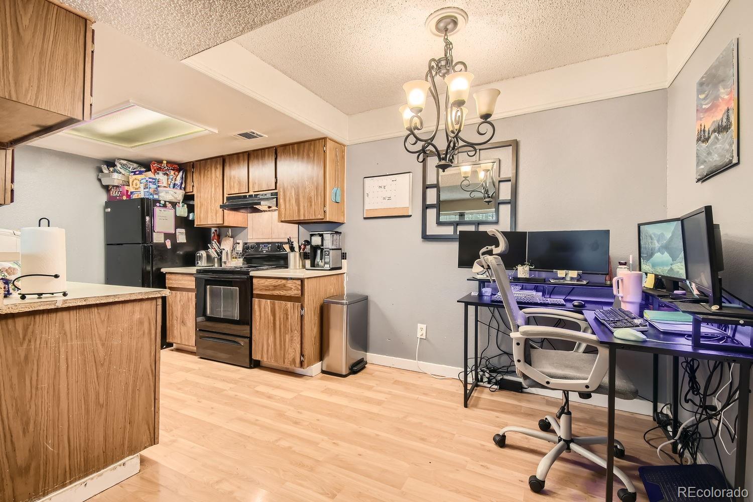 882 South Uravan Court Aurora, CO 80017 - Photo 4 of 33 a kitchen that has a lot of cabinets furniture and stainless steel appliances