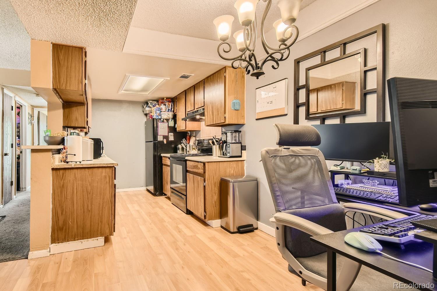 882 South Uravan Court Aurora, CO 80017 - Photo 5 of 33 a living room with furniture and a flat screen tv