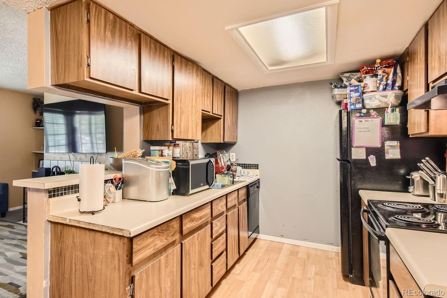 882 South Uravan Court Aurora, CO 80017 - Photo 7 of 33 a kitchen with stainless steel appliances granite countertop a sink stove and cabinets