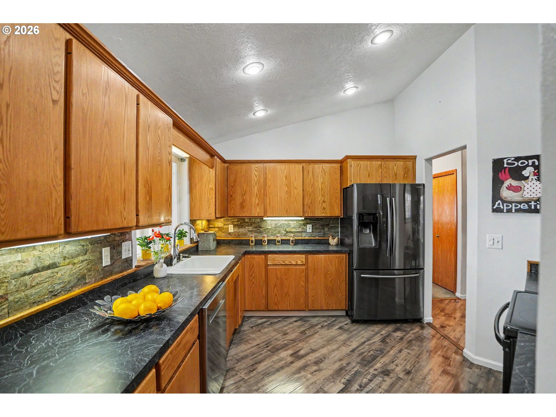 2662 South 12th Street Lebanon, OR 97355 - Photo 13 of 38 a kitchen with refrigerator and cabinets
