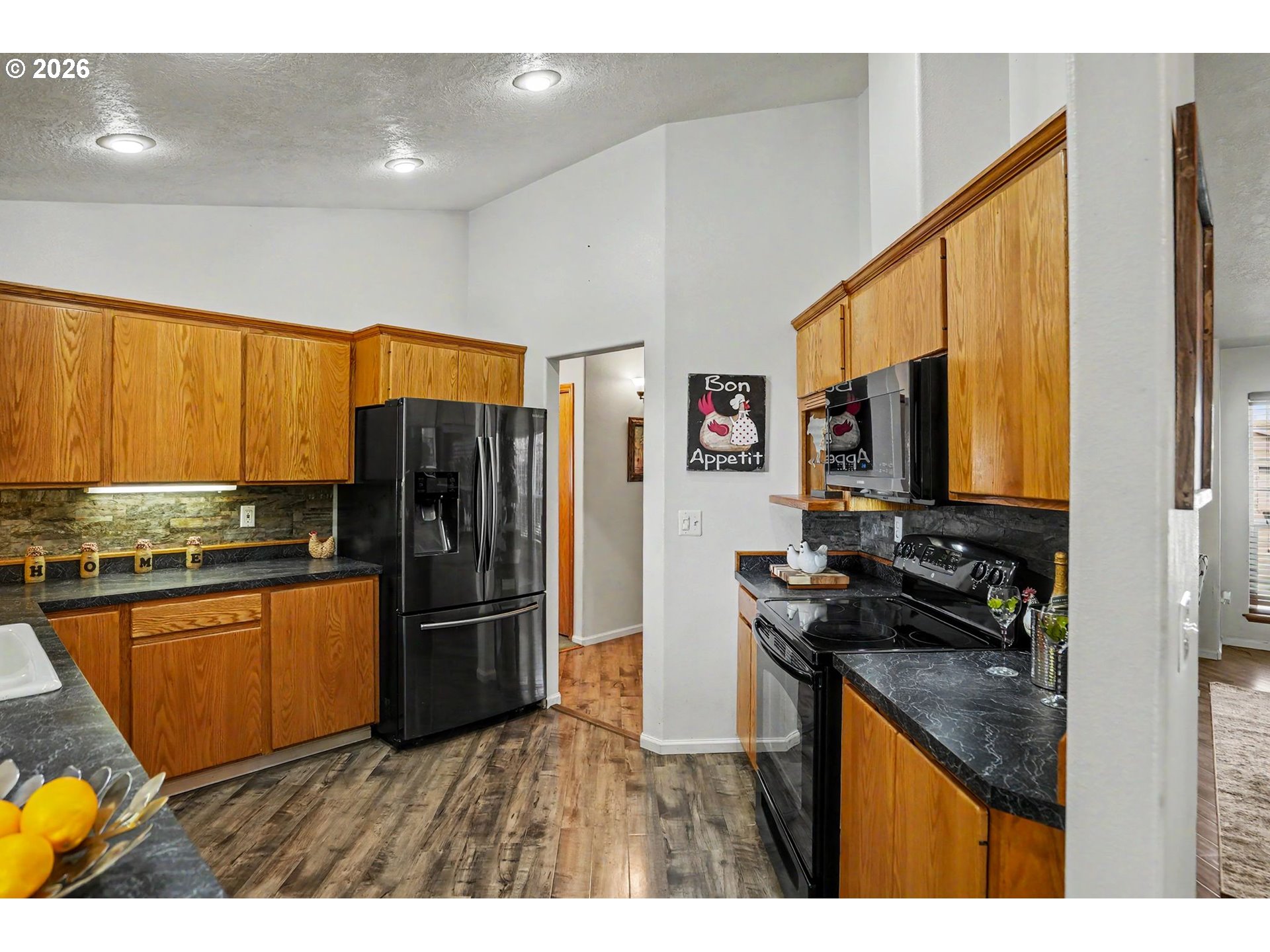 2662 South 12th Street Lebanon, OR 97355 - Photo 14 of 38 a kitchen with stainless steel appliances granite countertop a refrigerator a stove and a sink