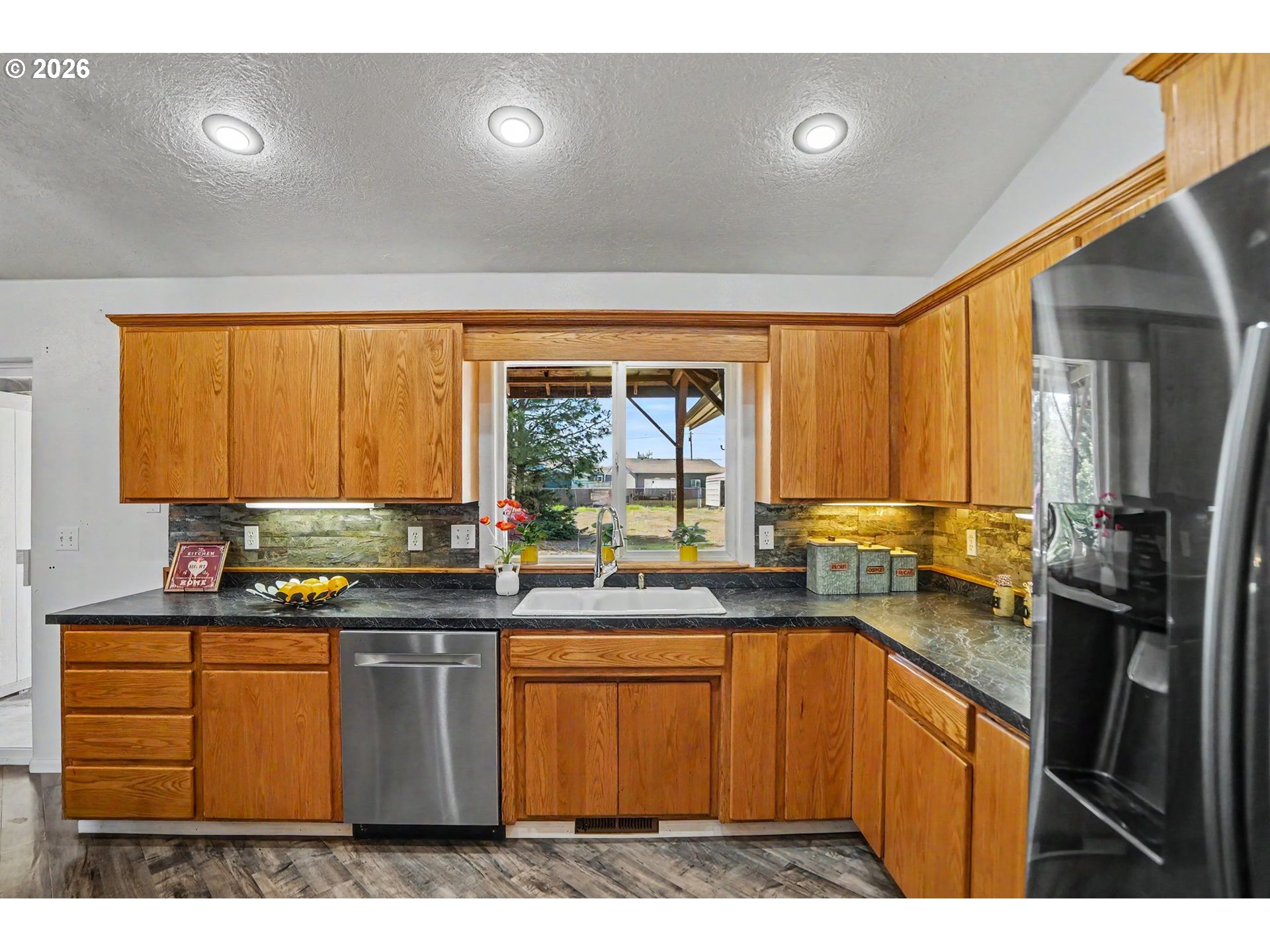 2662 South 12th Street Lebanon, OR 97355 - Photo 16 of 38 a kitchen with a sink stove and refrigerator
