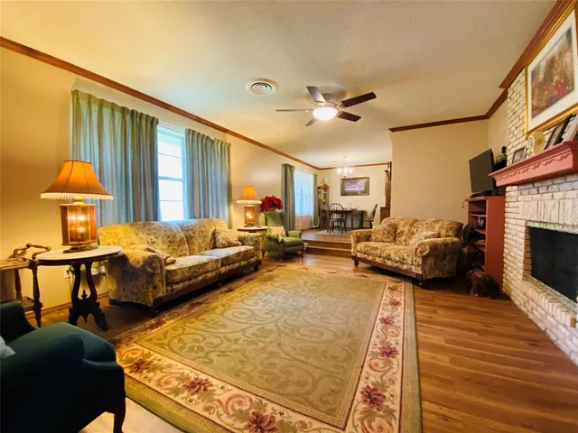 a living room with furniture a rug and a fireplace