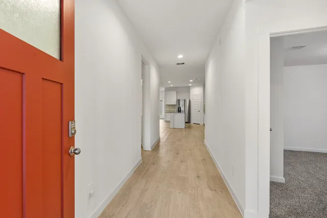 a view of a hallway with a wooden floor
