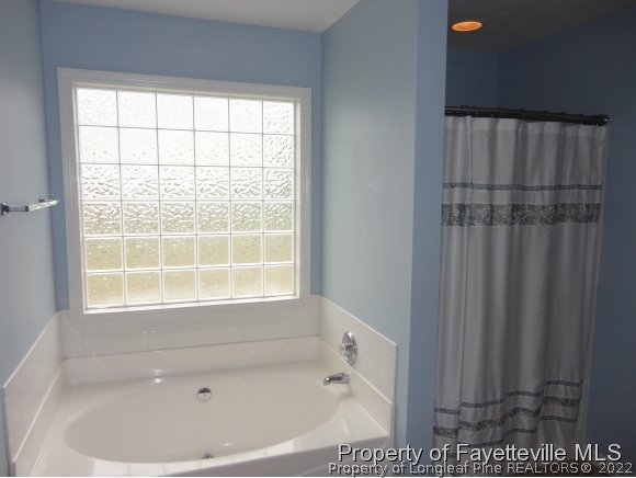 5432 Arnette Road Hope Mills, NC 28348 - Photo 13 of 25 a bath tub sitting next to a window