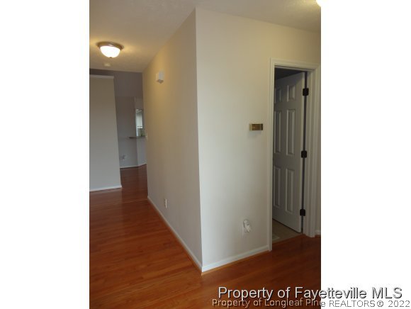 5432 Arnette Road Hope Mills, NC 28348 - Photo 3 of 25 a view of a hallway with wooden floor
