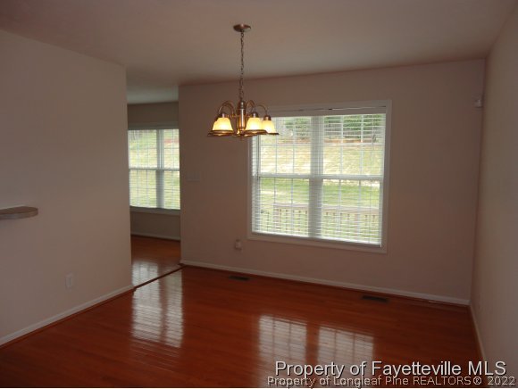 5432 Arnette Road Hope Mills, NC 28348 - Photo 5 of 25 a view of an empty room with wooden floor and a window