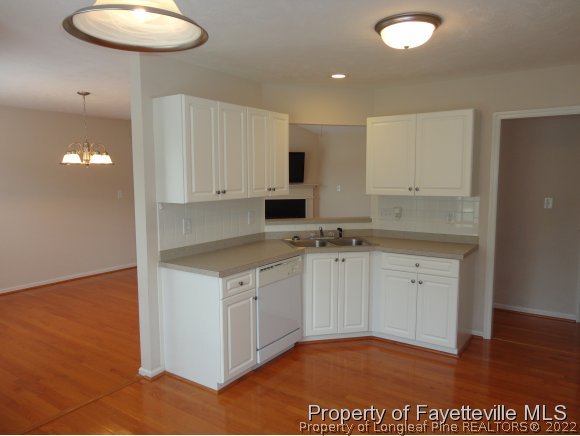 5432 Arnette Road Hope Mills, NC 28348 - Photo 8 of 25 a kitchen with stainless steel appliances granite countertop a stove a sink and a microwave
