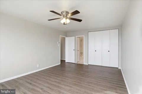 a white toilet sitting next to a white walls