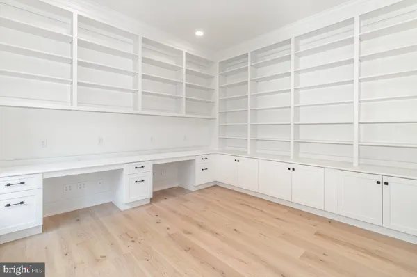 a room with a white walls and cabinet
