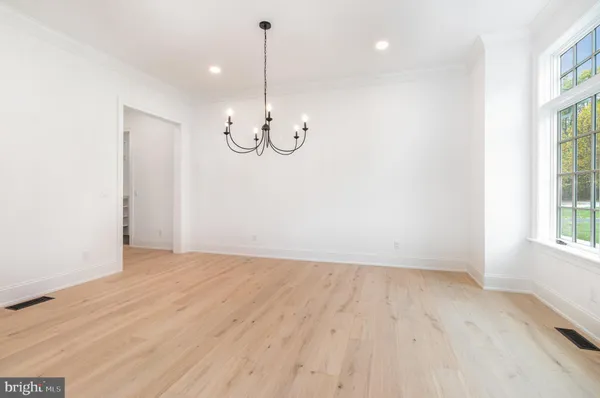 a view of a room with wooden floor and windows