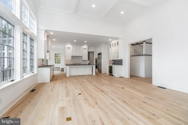 a view of kitchen with wooden floor and electronic appliances