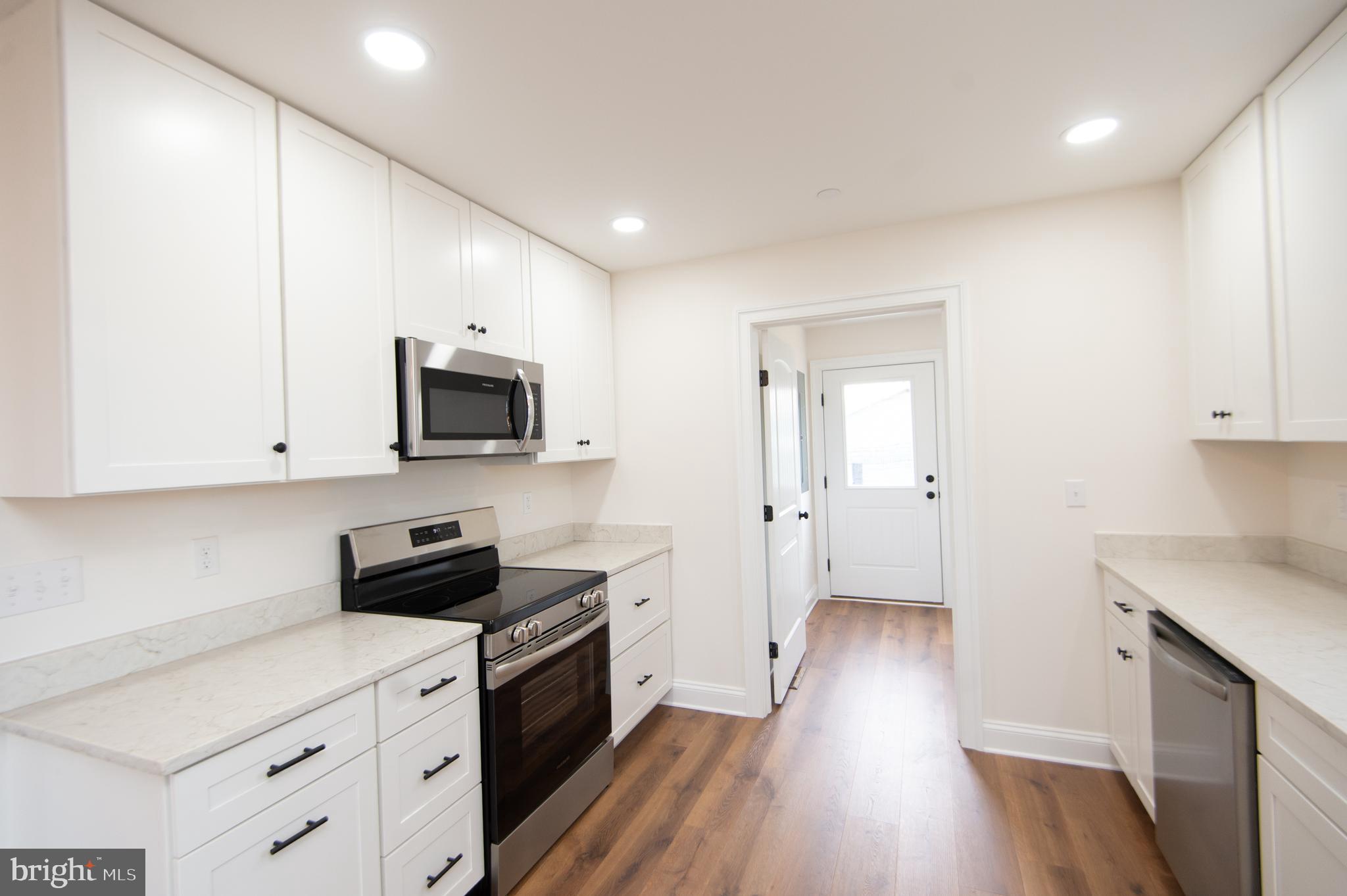 120 Academy Street Secretary, MD 21664 - Photo 13 of 46 a kitchen with a sink a microwave and cabinets