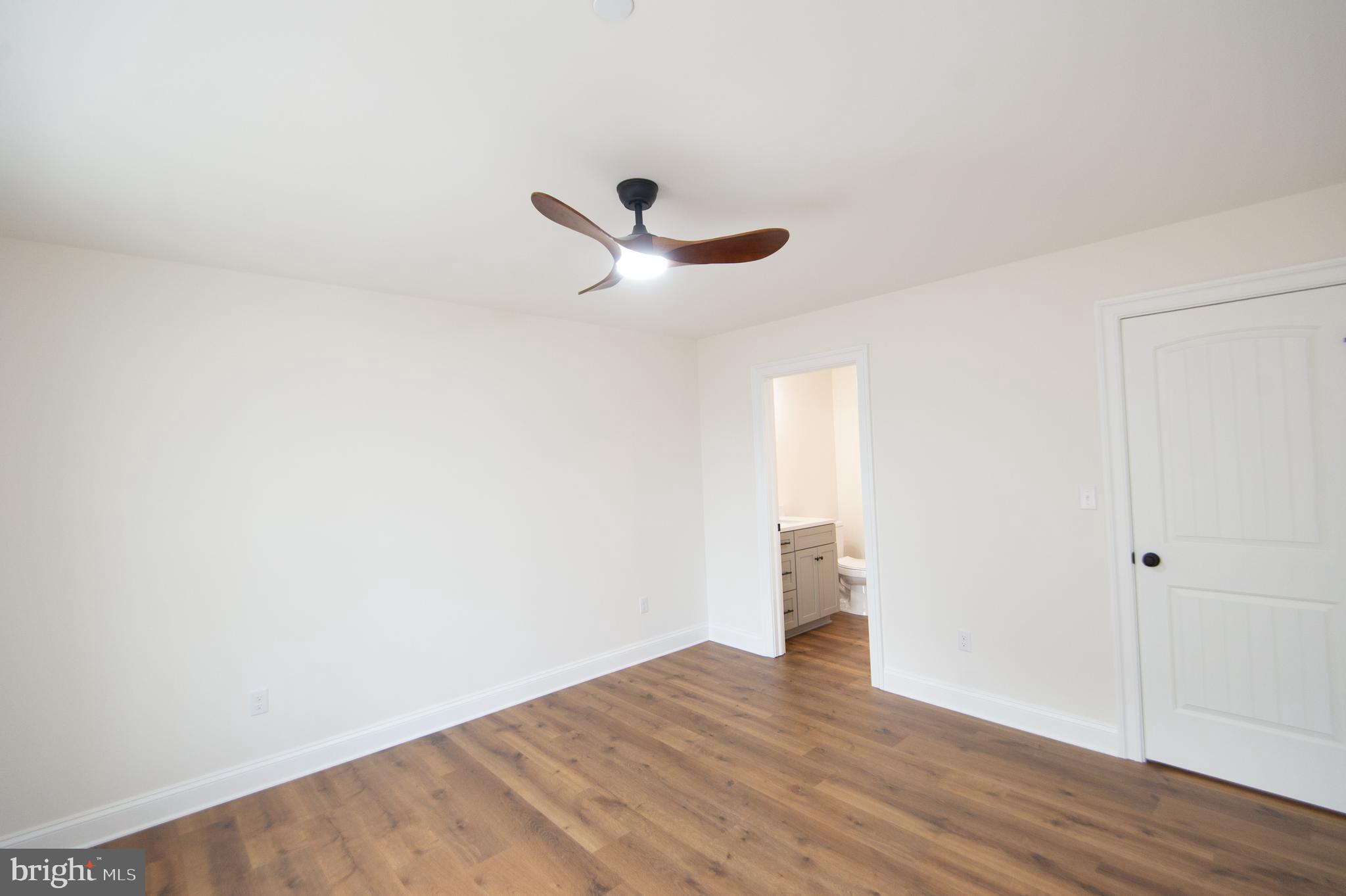 120 Academy Street Secretary, MD 21664 - Photo 15 of 46 a view of a room with wooden floor and a ceiling fan
