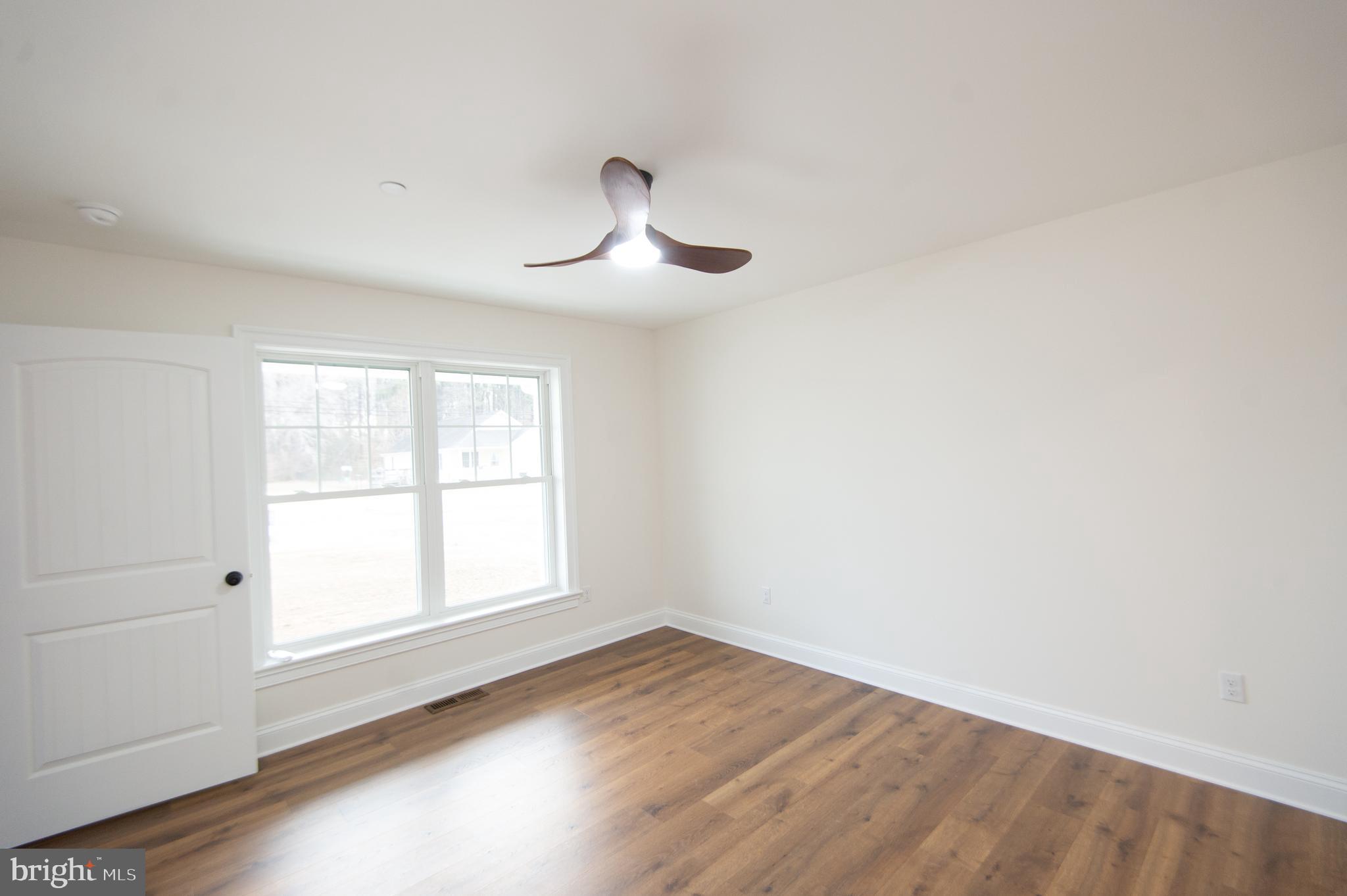 120 Academy Street Secretary, MD 21664 - Photo 18 of 46 an empty room with wooden floor and windows