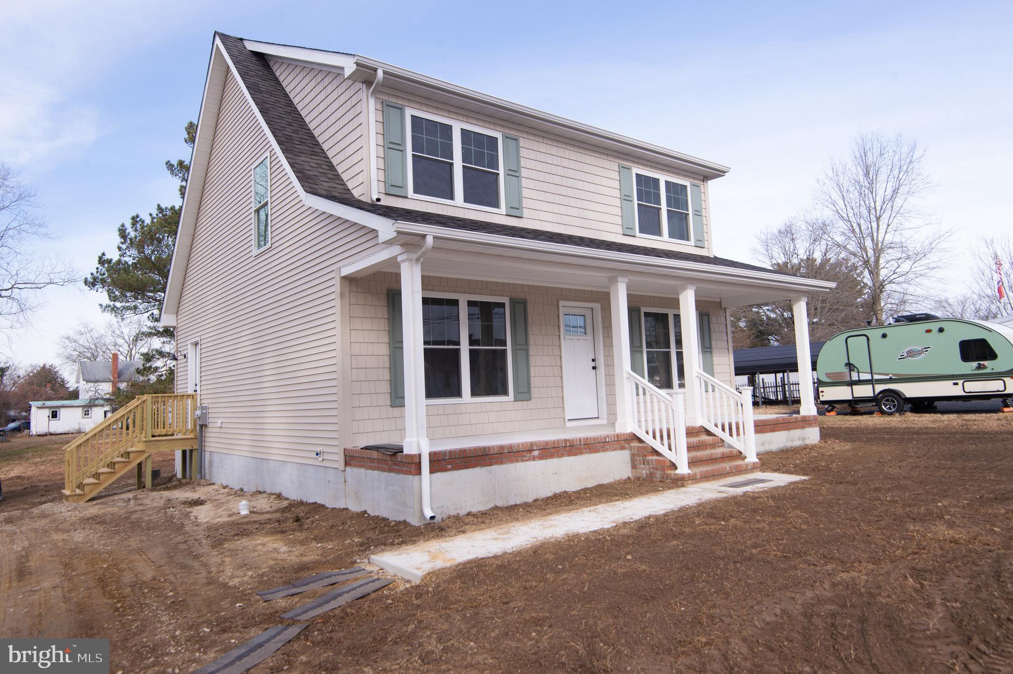 120 Academy Street Secretary, MD 21664 - Photo 2 of 46 a view of a house with backyard and parking area