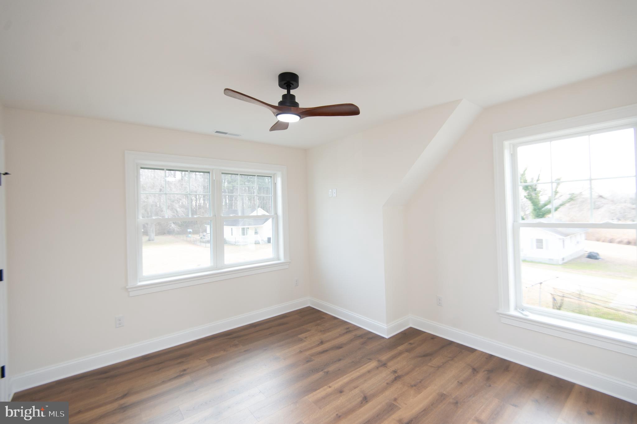120 Academy Street Secretary, MD 21664 - Photo 25 of 46 a view of an empty room with wooden floor and a window