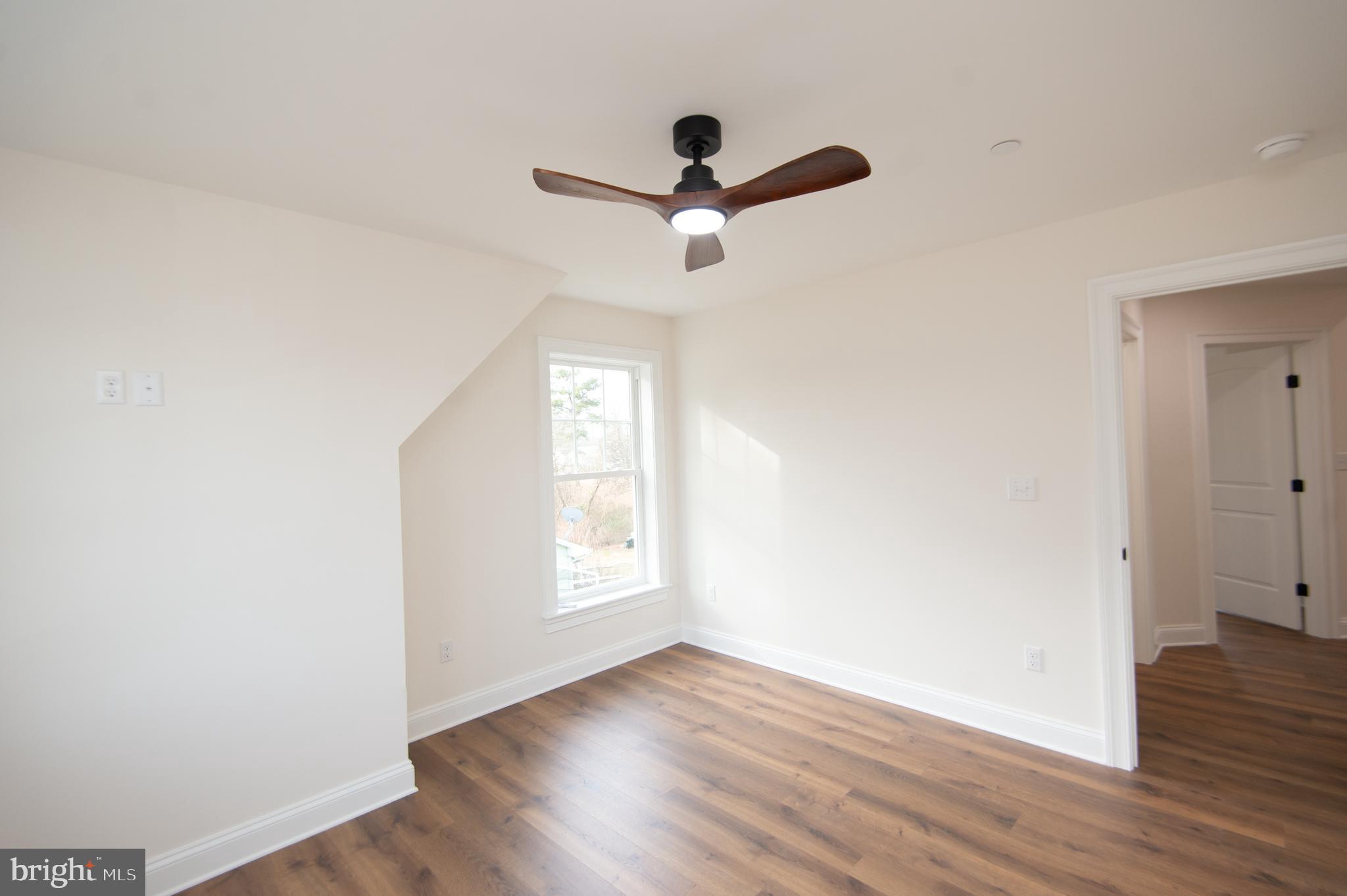 120 Academy Street Secretary, MD 21664 - Photo 26 of 46 a view of empty room with wooden floor and fan