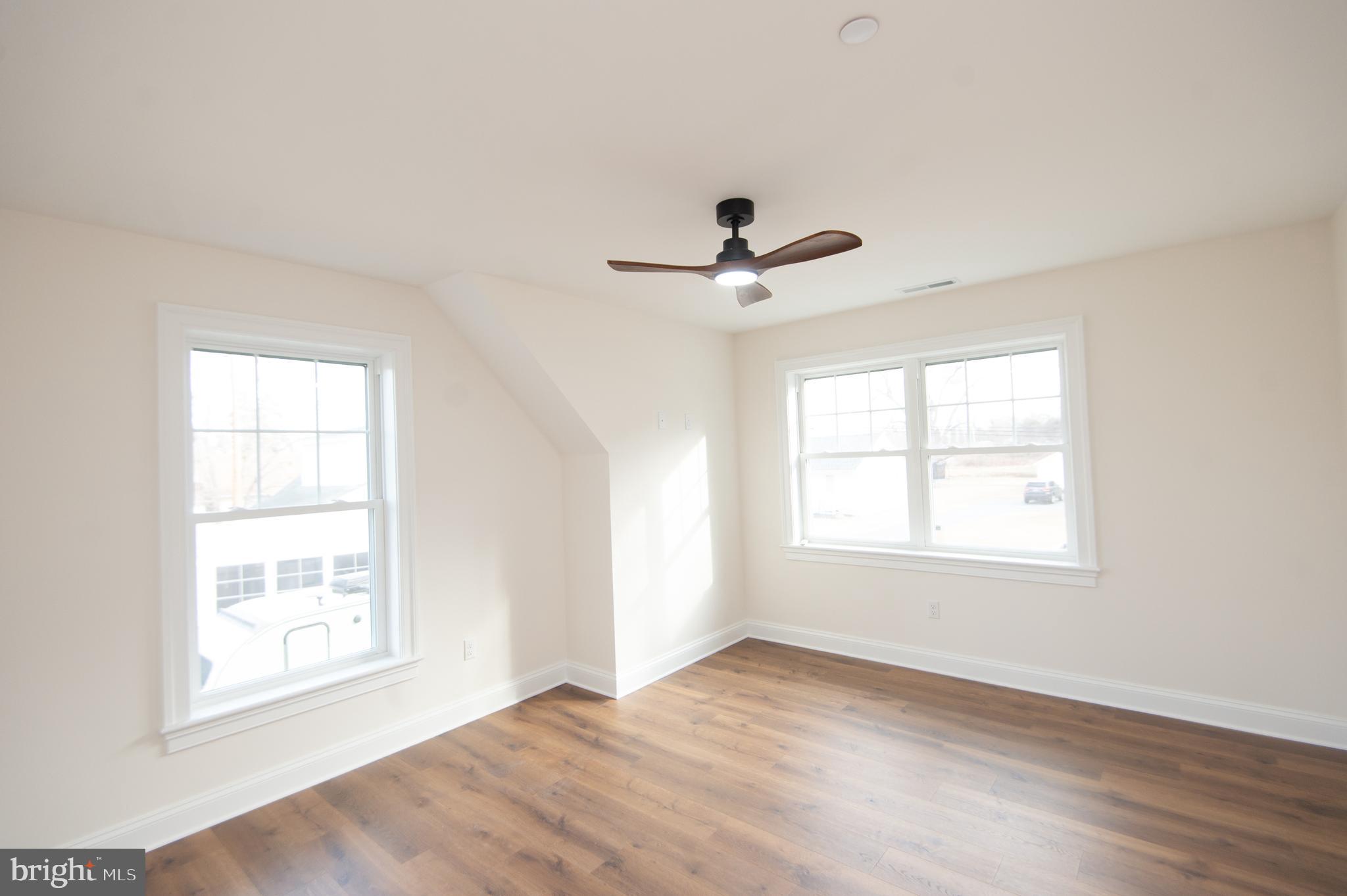 120 Academy Street Secretary, MD 21664 - Photo 34 of 46 a view of an empty room with a window and wooden floor