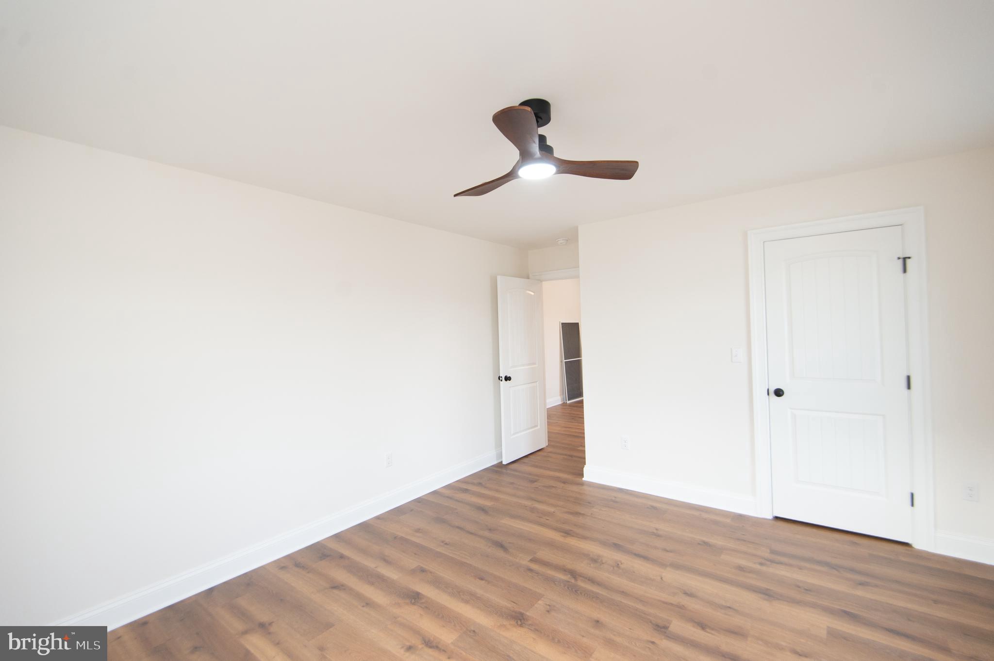 120 Academy Street Secretary, MD 21664 - Photo 36 of 46 a view of a room with wooden floor and ceiling fan