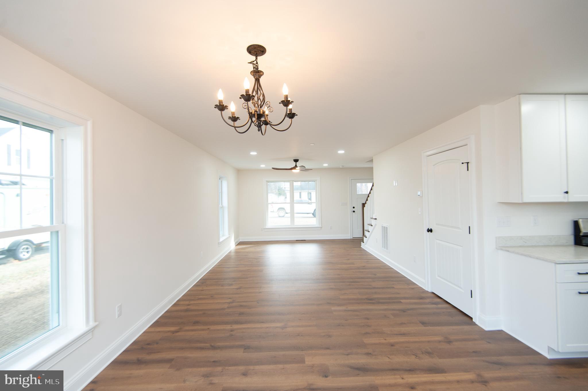 120 Academy Street Secretary, MD 21664 - Photo 9 of 46 a view of an empty room with wooden floor and a window