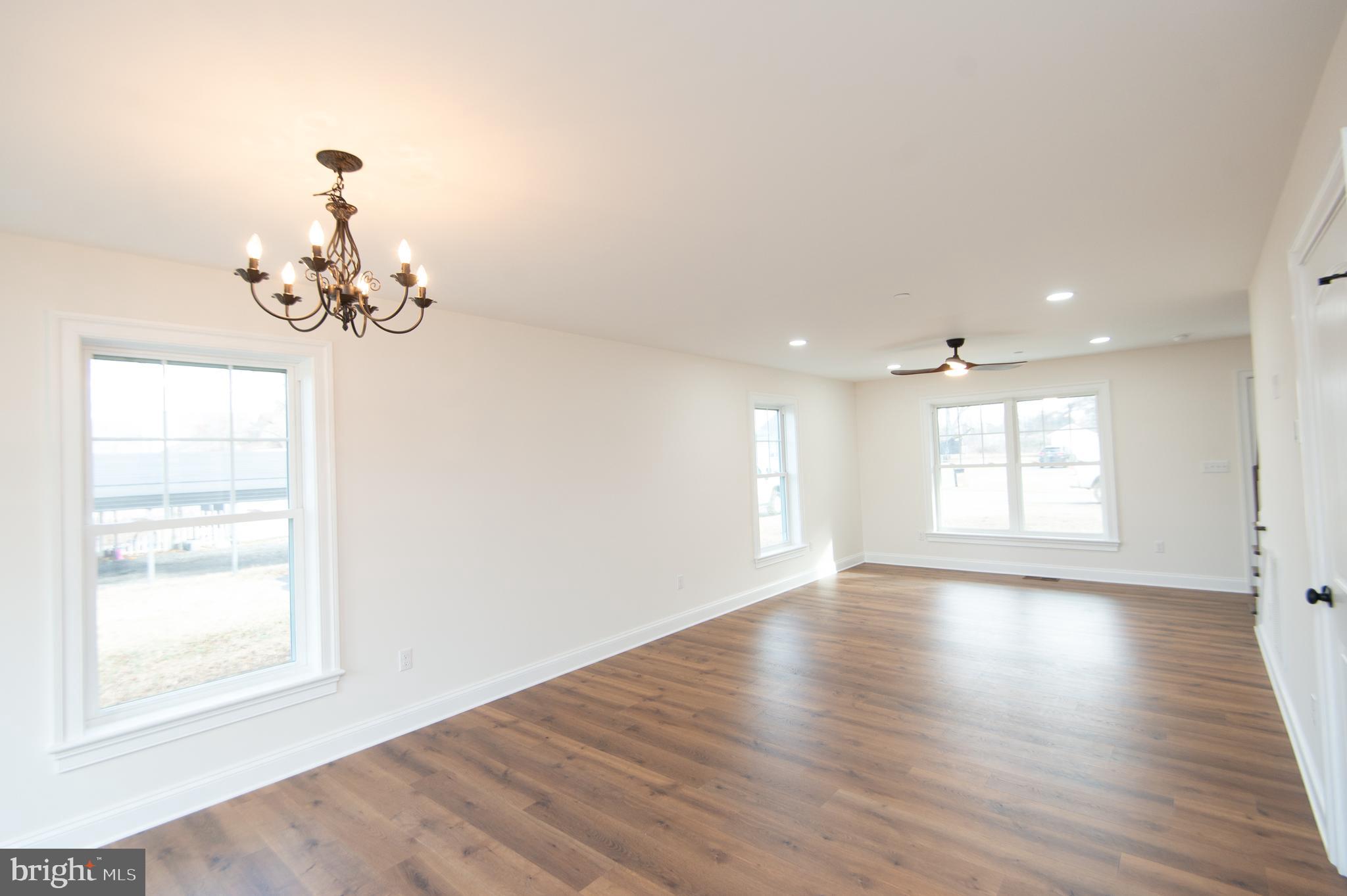 120 Academy Street Secretary, MD 21664 - Photo 10 of 46 a view of a room with wooden floor and windows