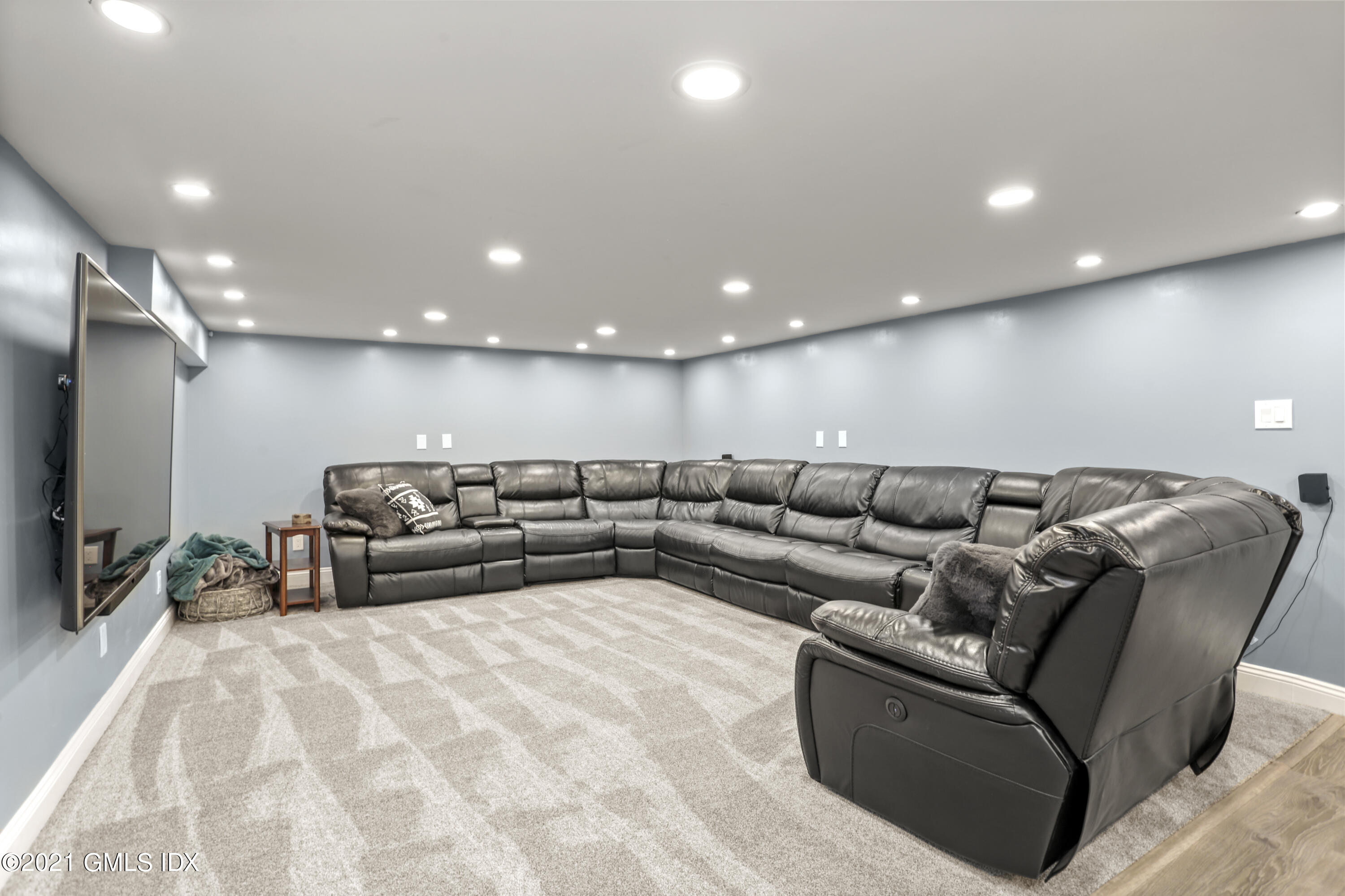 44 Bonwit Road Riverside, CT 06878 - Photo 20 of 22 a living room with a couch and a flat screen tv