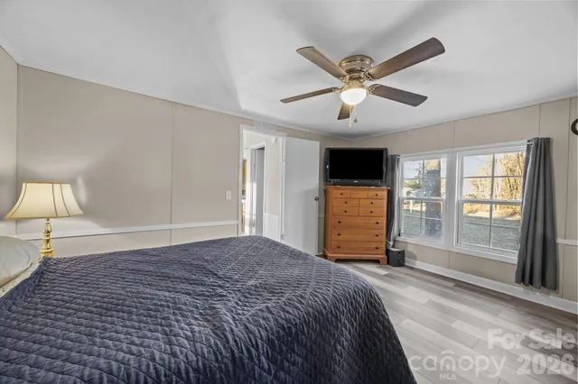 a bedroom with a bed and a large window