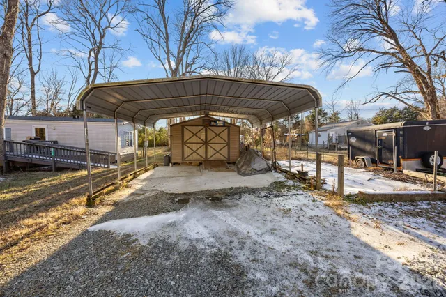 a view of a backyard with wooden fence
