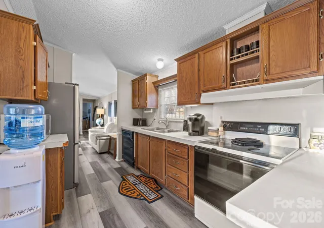 a kitchen with stainless steel appliances granite countertop a stove and a sink