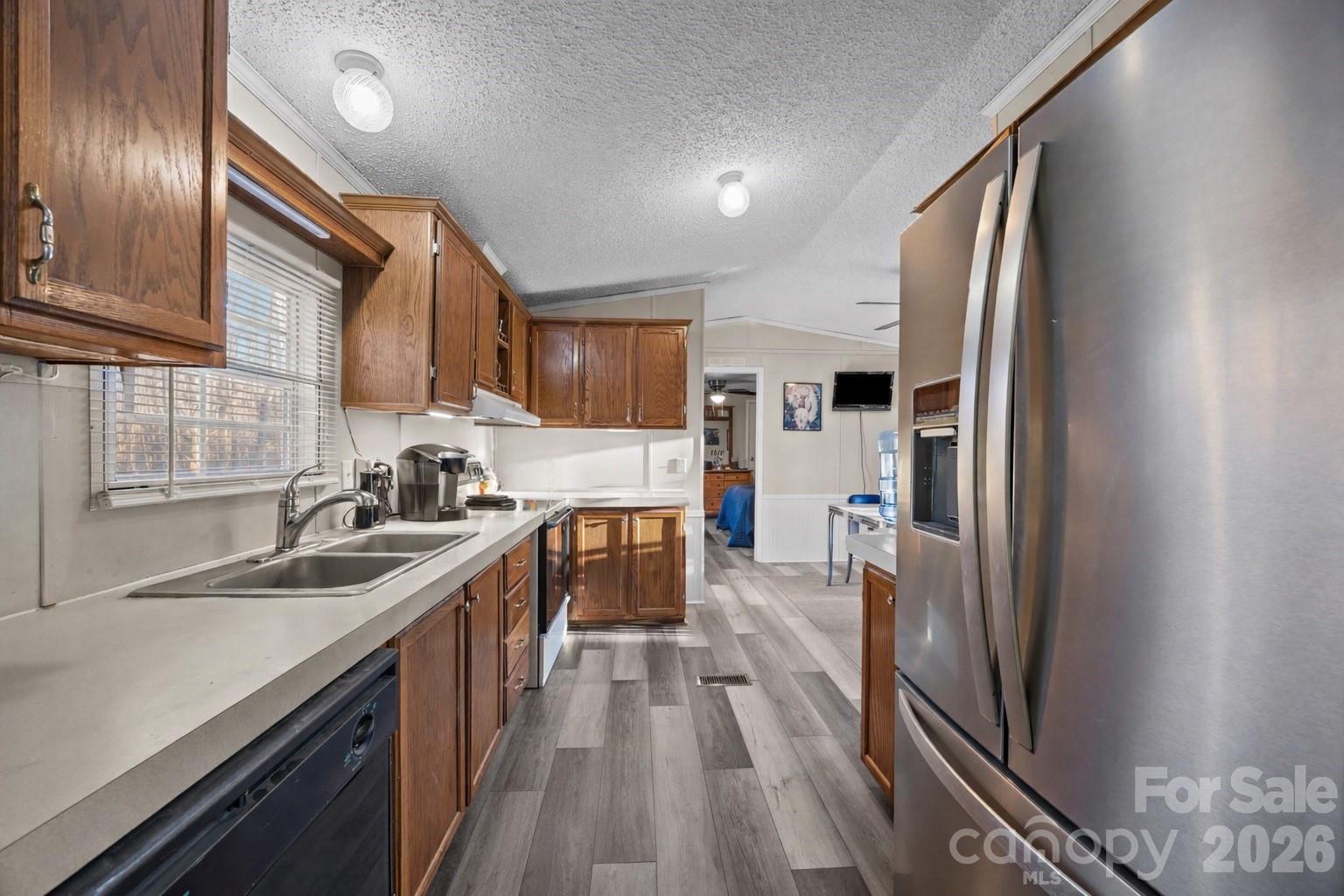 5819 Mt Gallant Road Rock Hill, SC 29732 - Photo 8 of 20 a kitchen with stainless steel appliances granite countertop a refrigerator a sink dishwasher a stove and a sink with wooden floor