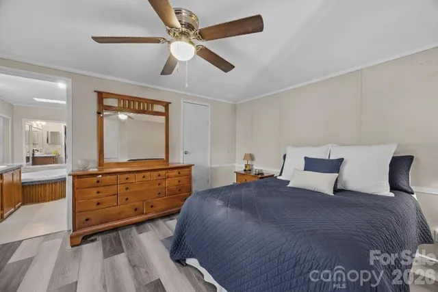 a bedroom with a large bed and a chandelier