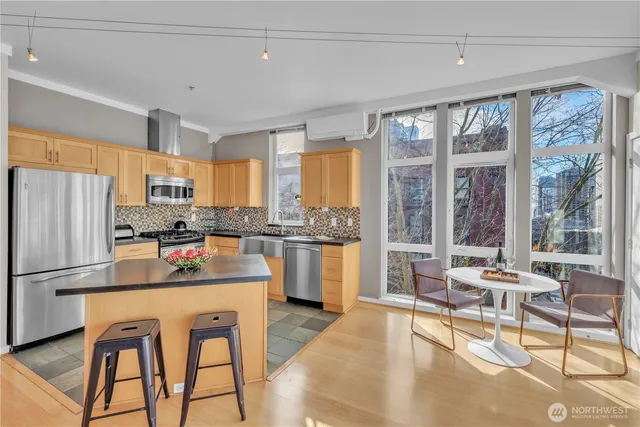 a kitchen view with stainless steel appliances a sink and cabinets