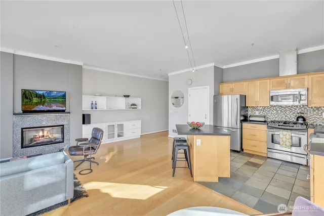 a view of a hallway with wooden floor and a living room