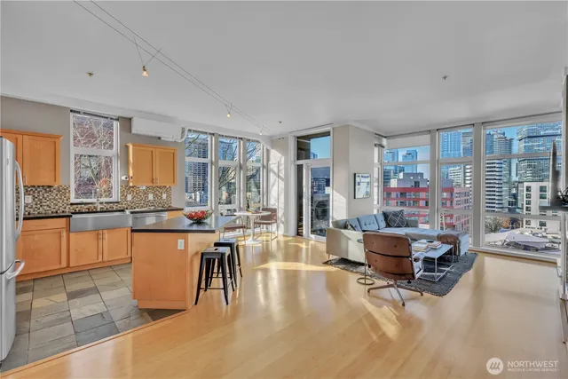 a living room with furniture a flat screen tv and a large window