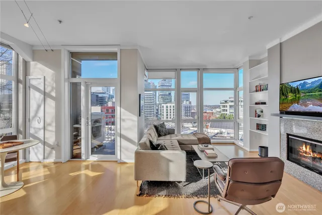 a living room with furniture and a floor to ceiling window