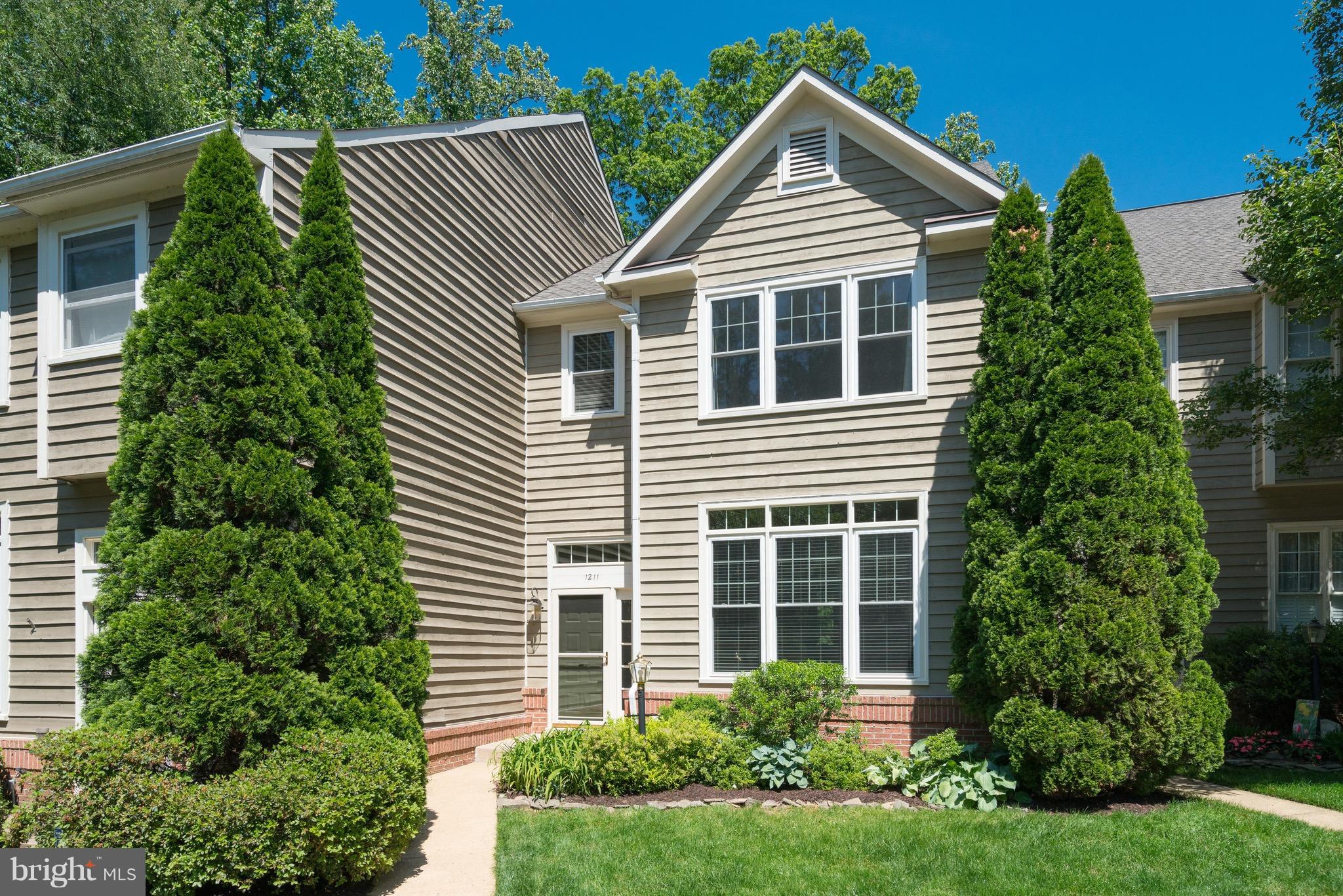 1211 Weatherstone Court Reston, VA 20194 - Photo 1 of 30 a front view of a house with a yard