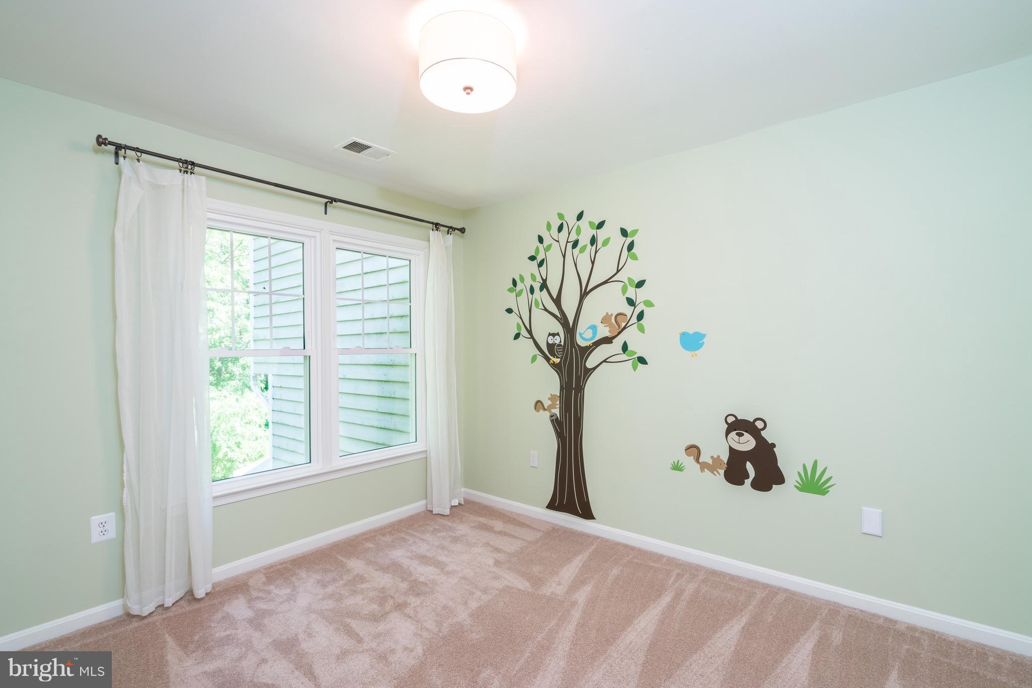 1211 Weatherstone Court Reston, VA 20194 - Photo 20 of 30 a view of a bedroom with a window and a ceiling fan
