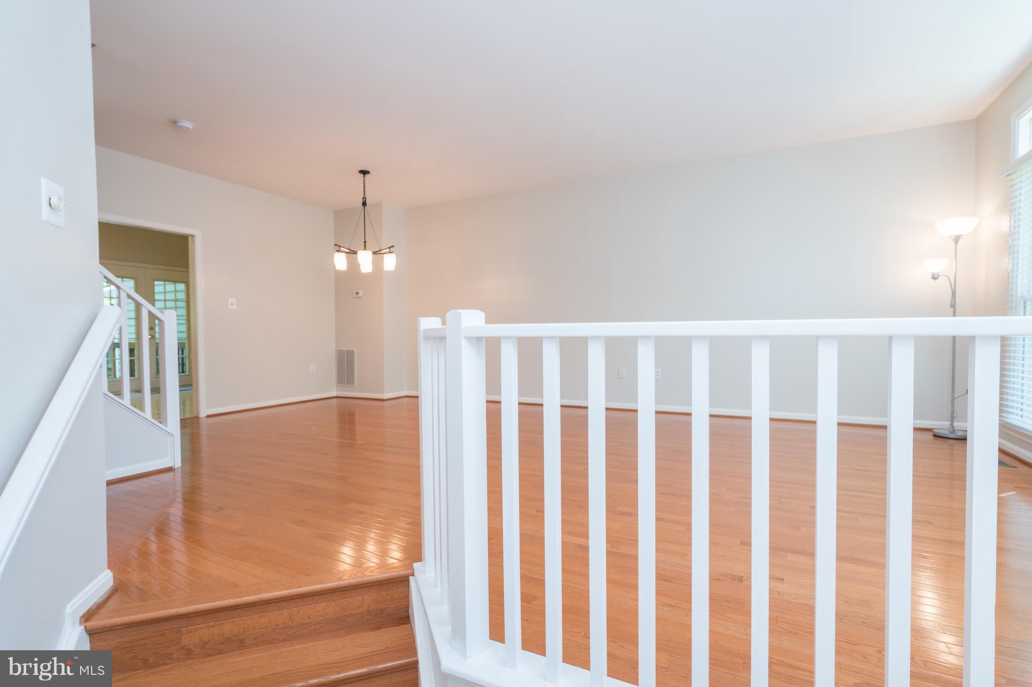 1211 Weatherstone Court Reston, VA 20194 - Photo 3 of 30 a view of staircase with railing and a chandelier