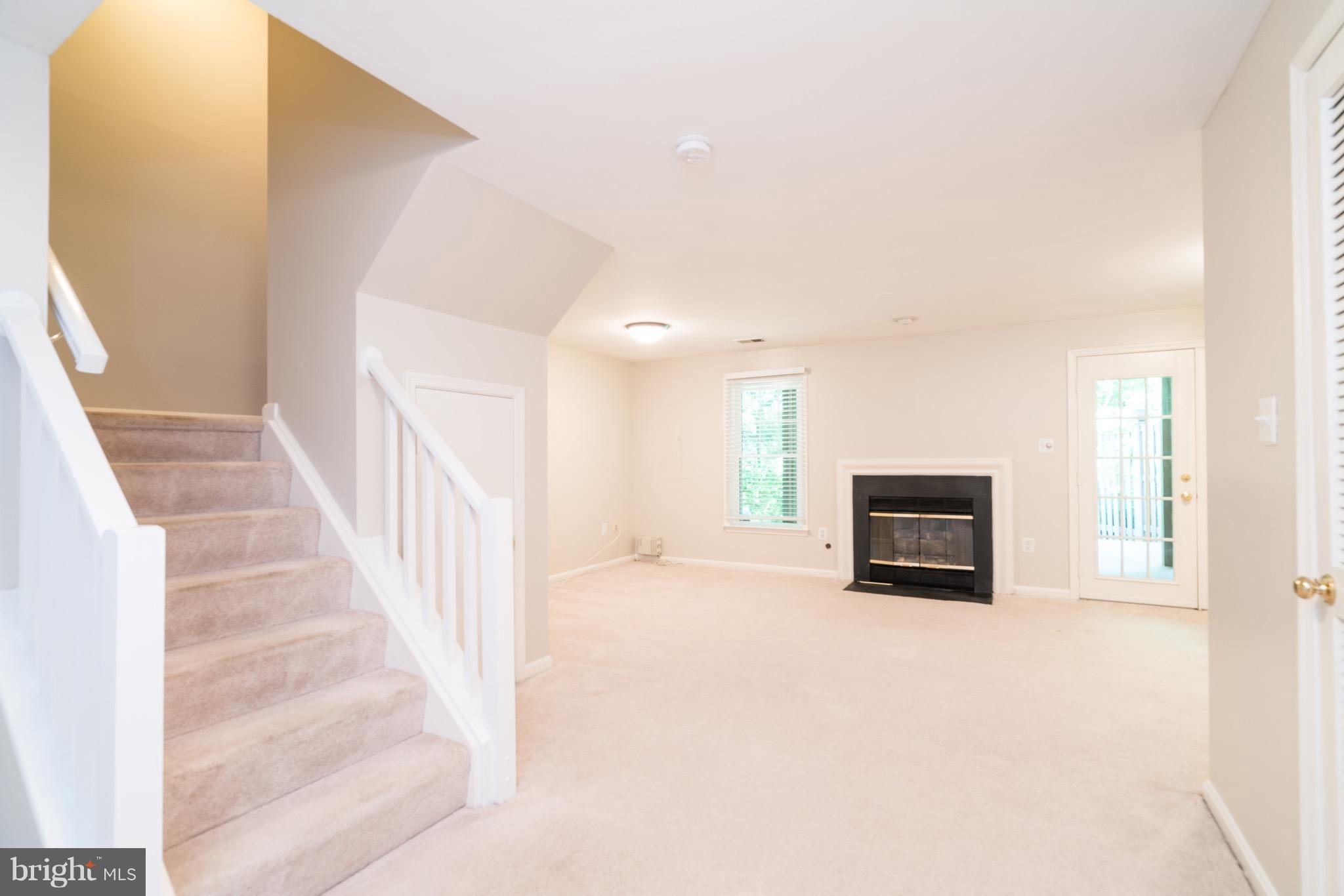 1211 Weatherstone Court Reston, VA 20194 - Photo 22 of 30 a view of an empty room with wooden floor and a window